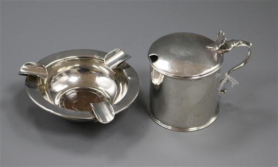 A George III silver mustard, London 1785, maker Robert Hennell and a silver ashtray inset with a cartwheel penny.